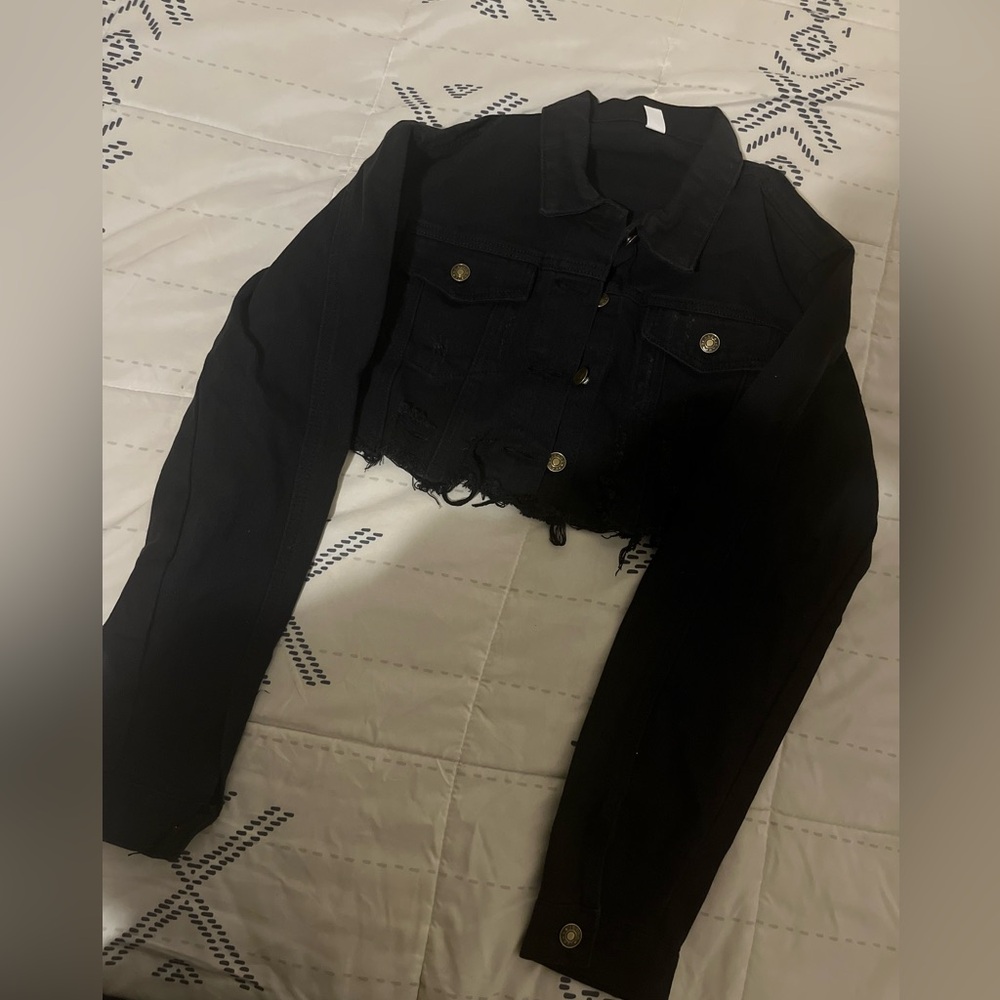 Black cropped distressed denim jacket.